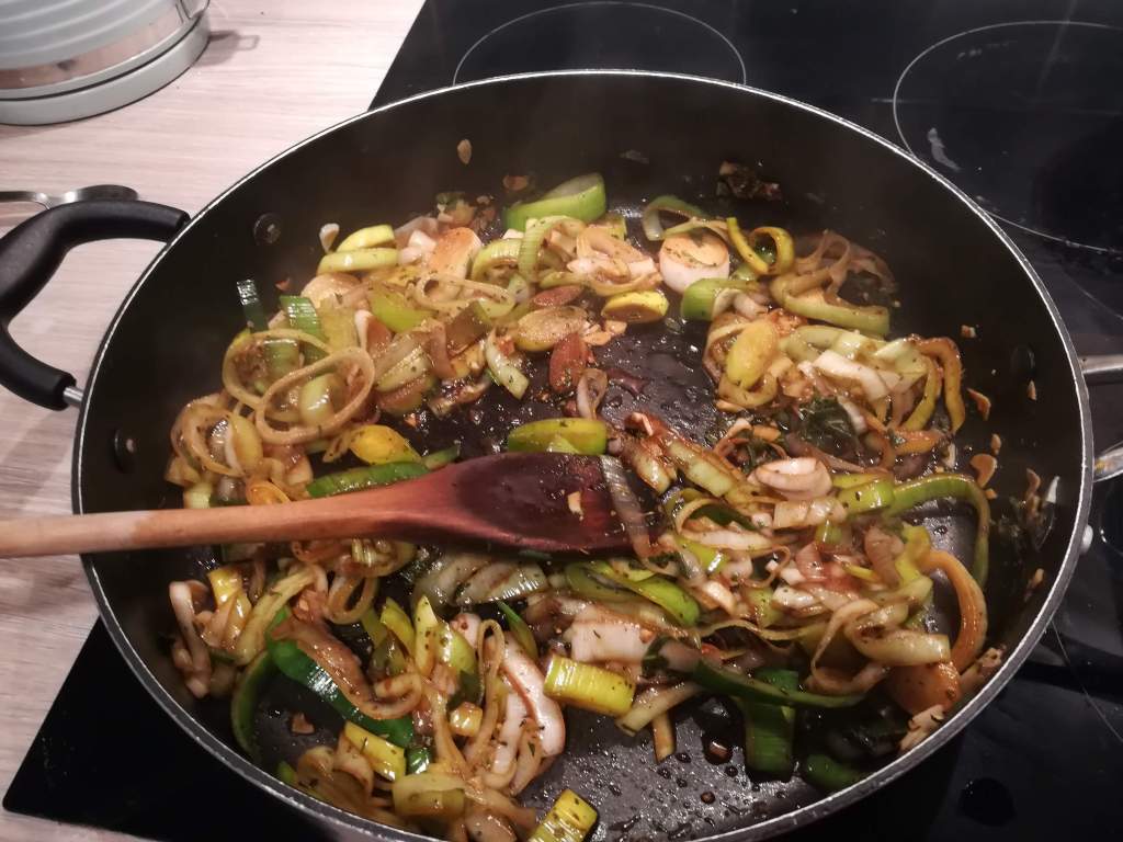 Leeks frying gently in a pan